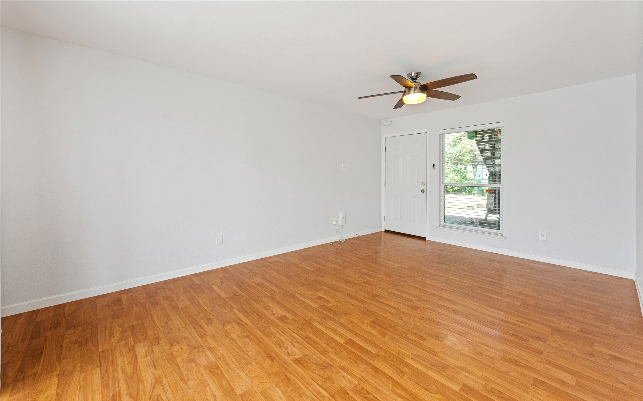 2124 Burton Drive, Unit 159 Austin, TX 78741 - Photo 4 of 23 A living space offers warm hardwood flooring and abundant natural light.
