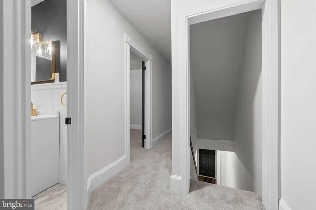 a view of a hallway with wooden floor