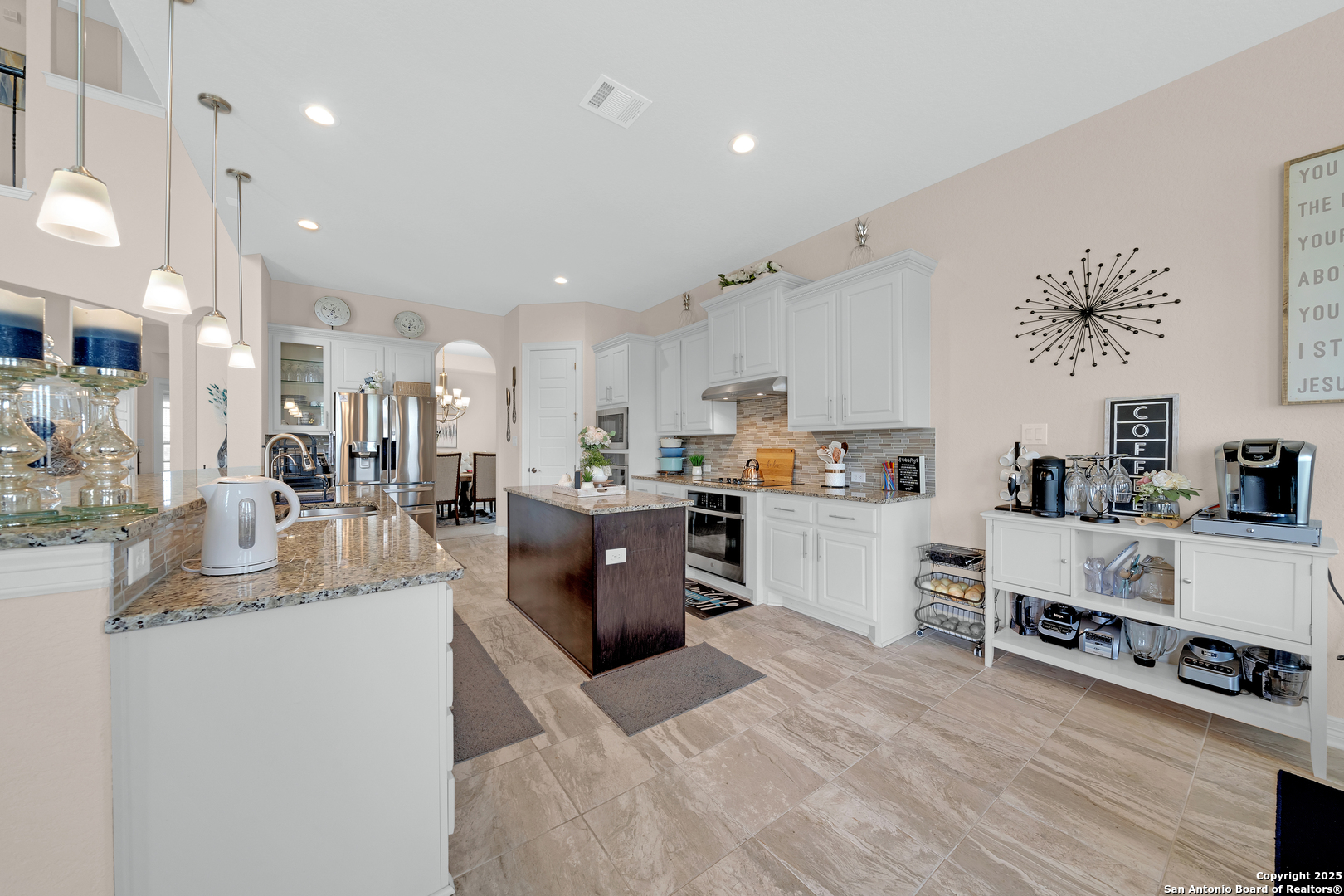 7151 Agarita Mist Fair Oaks Ranch, TX 78015 - Photo 15 of 49 a large white kitchen with lots of counter space and view of living room
