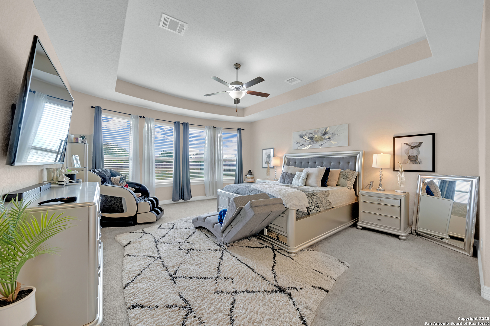 7151 Agarita Mist Fair Oaks Ranch, TX 78015 - Photo 18 of 49 a bedroom with a bed and a chandelier