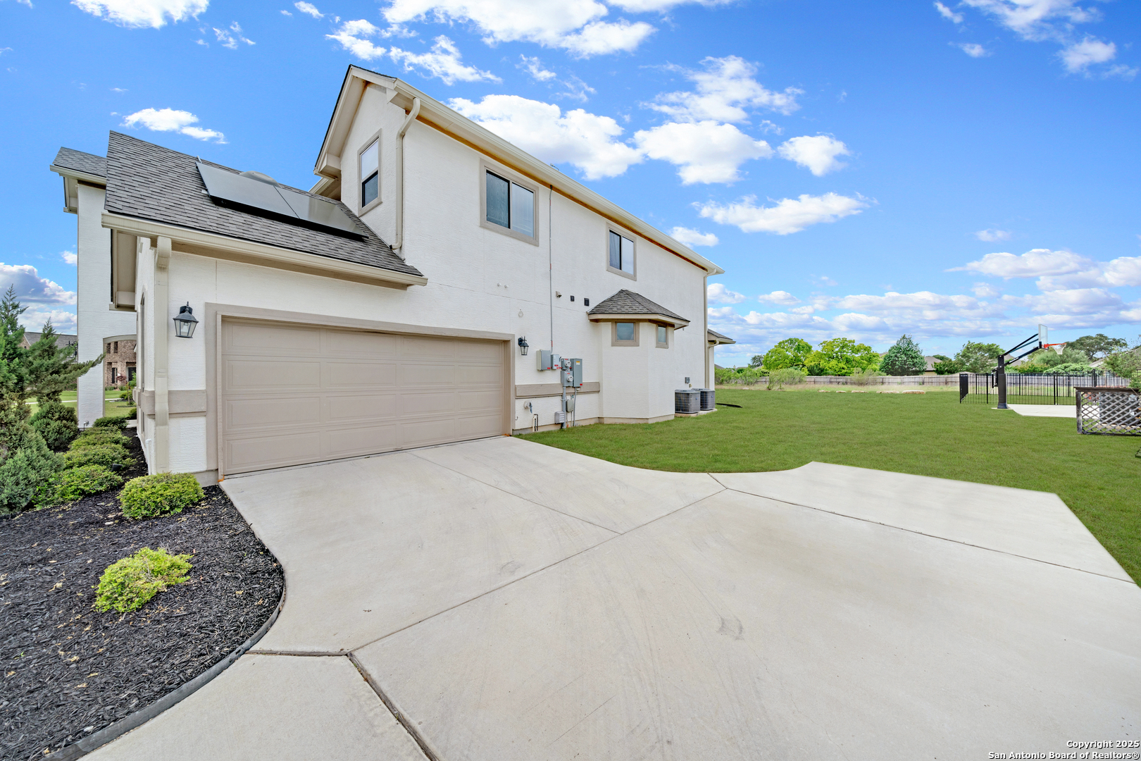 7151 Agarita Mist Fair Oaks Ranch, TX 78015 - Photo 2 of 49 a view of a white house with a yard