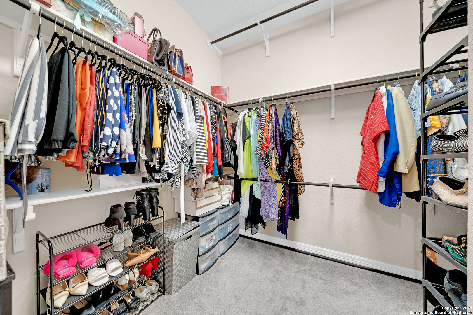 7151 Agarita Mist Fair Oaks Ranch, TX 78015 - Photo 24 of 49 a view of walk in closet with clothes and shoes