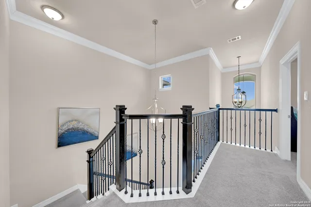 a view of a hallway with windows and stairs