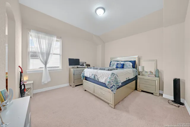 a bedroom with a bed and a flat tv screen