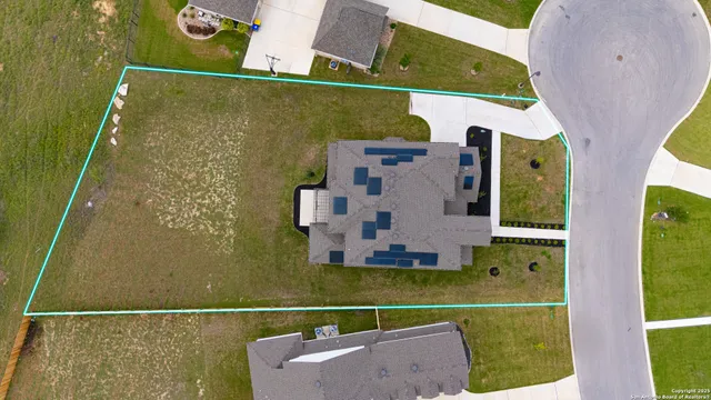 an aerial view of a house with a ocean view