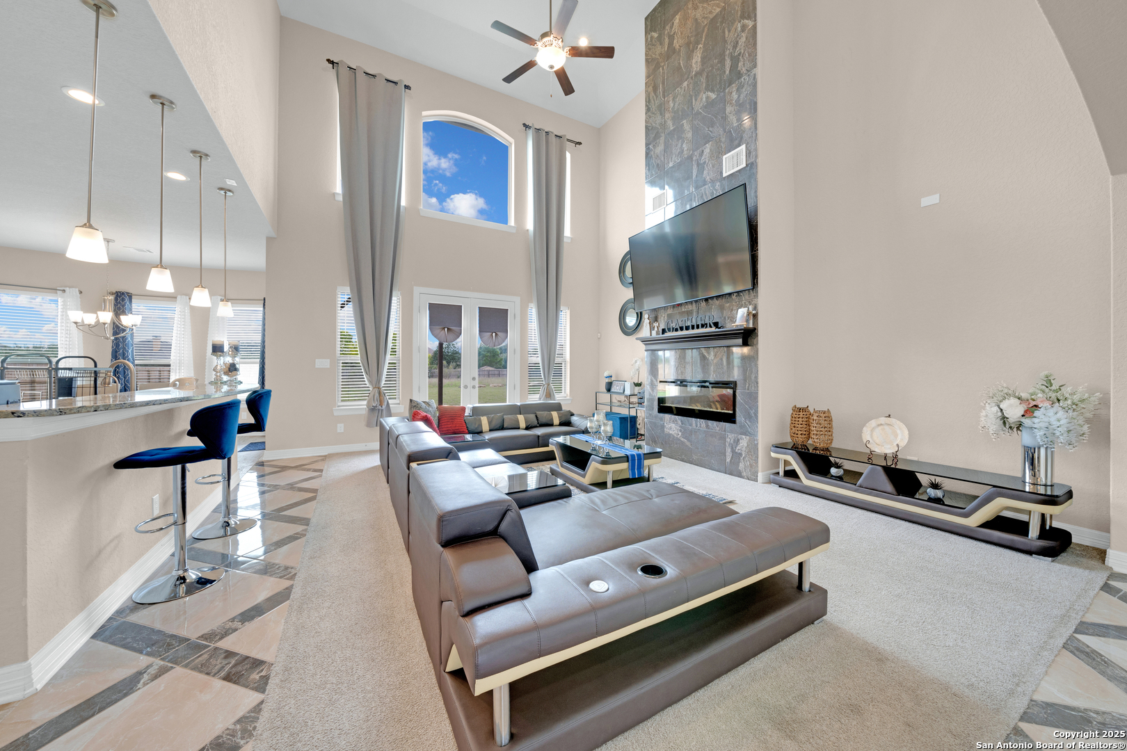 7151 Agarita Mist Fair Oaks Ranch, TX 78015 - Photo 7 of 49 a living room with furniture a flat screen tv and kitchen view