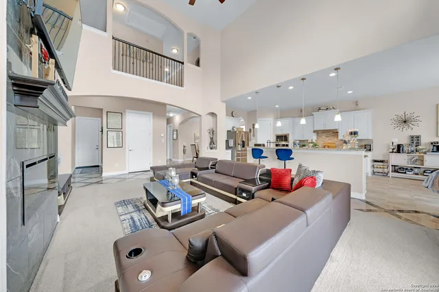 a living room with furniture kitchen view and a couch