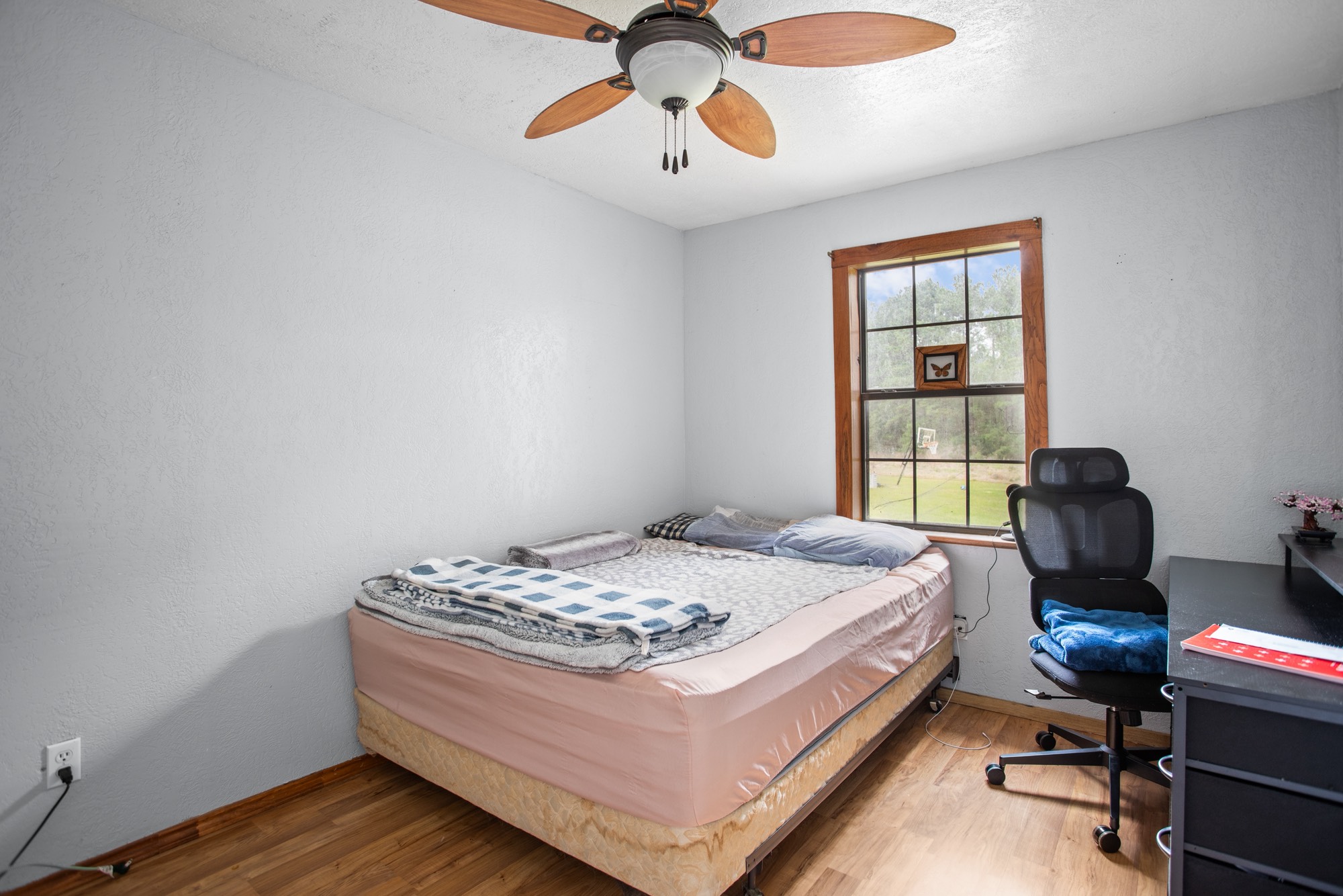 991 Herman Nerren Road Huntington, TX 75949 - Photo 11 of 23 a bedroom with a bed and a chandelier