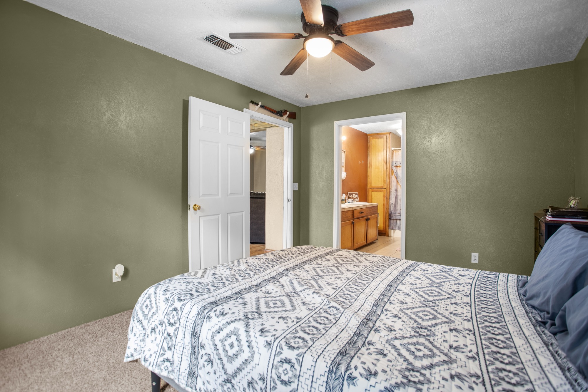 991 Herman Nerren Road Huntington, TX 75949 - Photo 16 of 23 a bedroom with a large bed and a chandelier