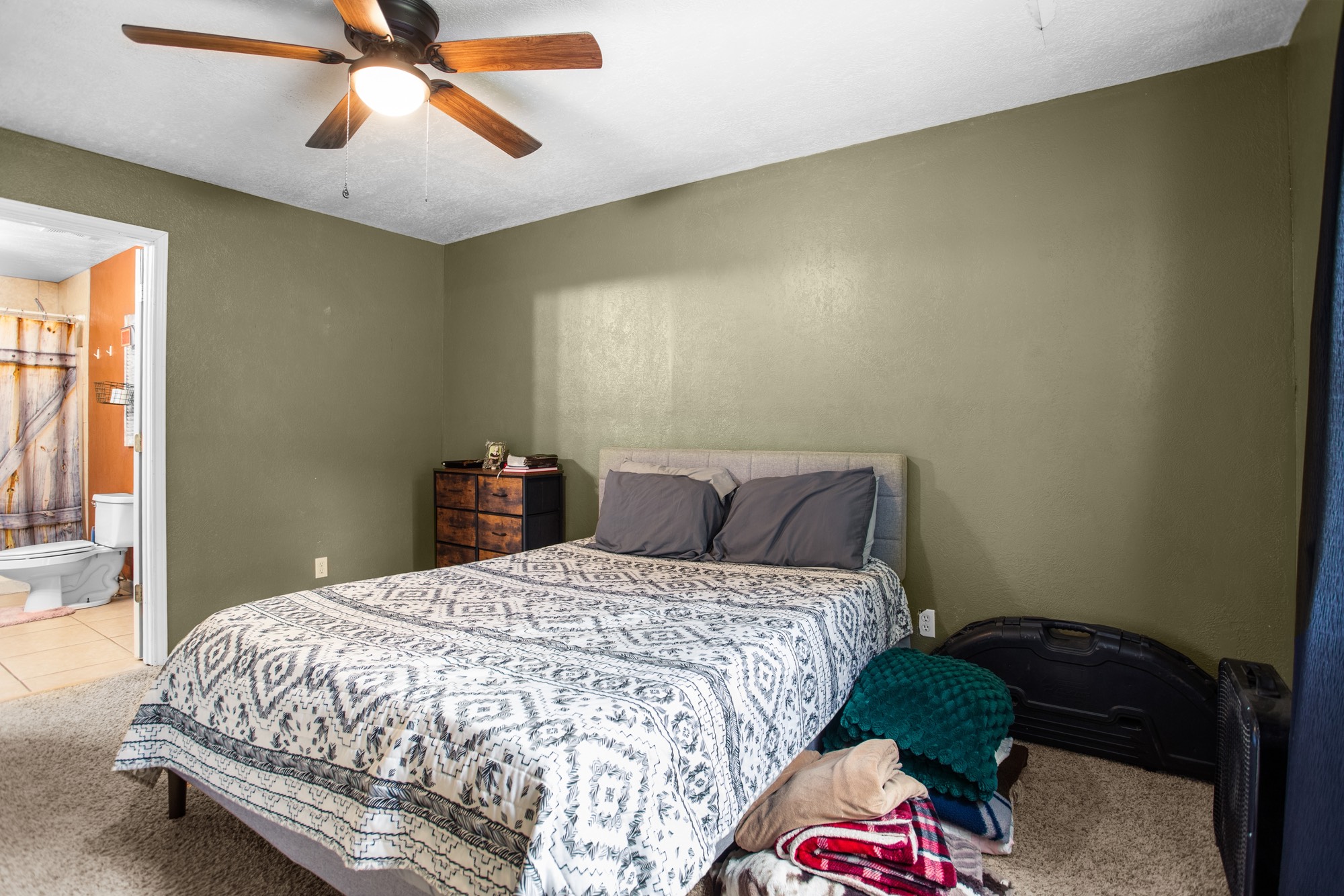 991 Herman Nerren Road Huntington, TX 75949 - Photo 19 of 23 a bedroom with a bed and a chandelier