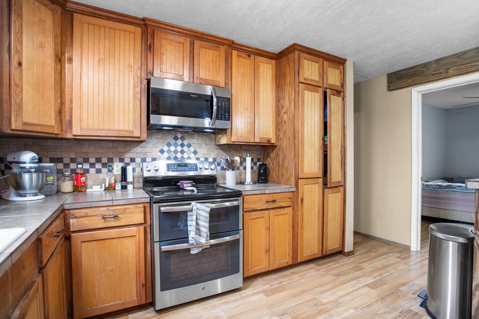 991 Herman Nerren Road Huntington, TX 75949 - Photo 10 of 23 a kitchen with stainless steel appliances granite countertop a stove a sink and a refrigerator