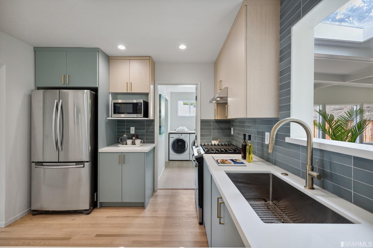 39 Idlewild Court Pacifica, CA 94044 - Photo 19 of 79 a kitchen with a refrigerator sink and wooden cabinets