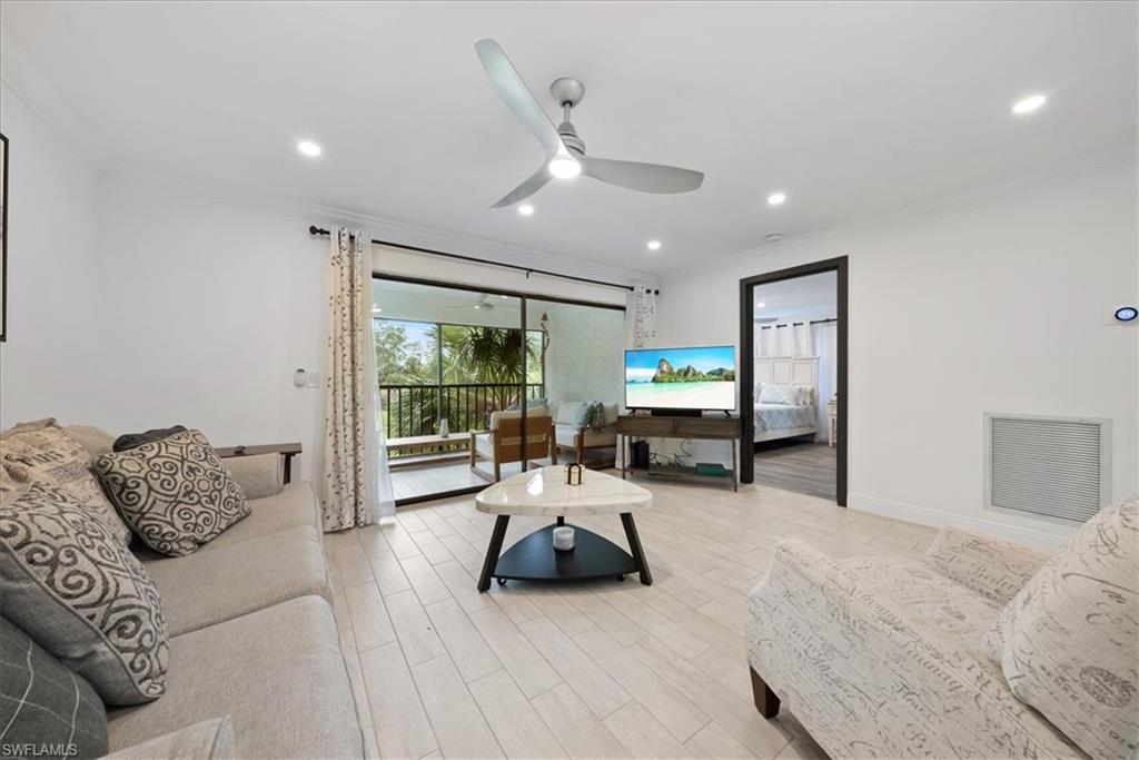 5841 Rattlesnake Hammock Road, Unit 2 Naples, FL 34113 - Photo 16 of 21 a living room with furniture and a large window