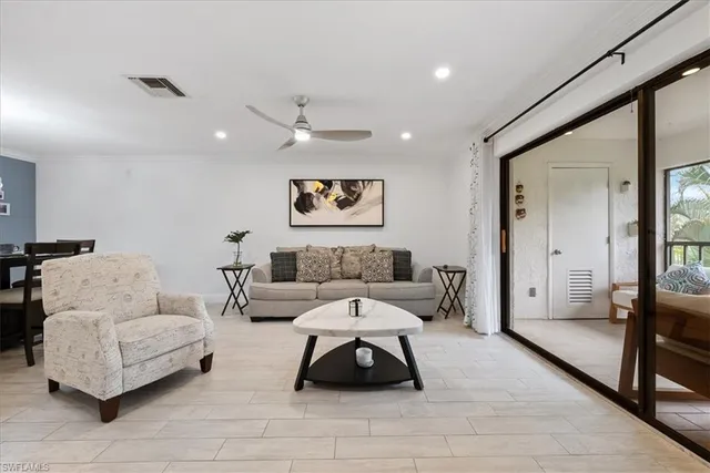 a living room with furniture and a large mirror