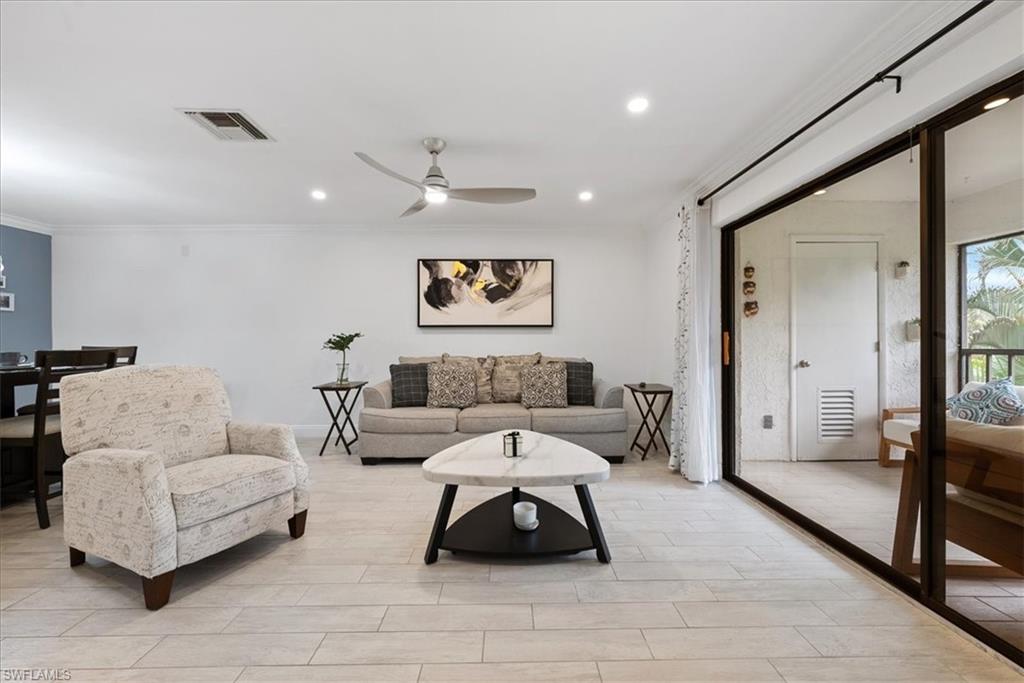 5841 Rattlesnake Hammock Road, Unit 2 Naples, FL 34113 - Photo 17 of 21 a living room with furniture and a large mirror