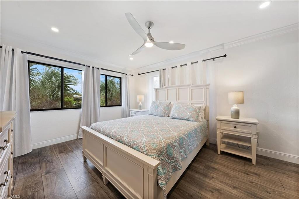 5841 Rattlesnake Hammock Road, Unit 2 Naples, FL 34113 - Photo 19 of 21 a bed sitting in a spacious bedroom next to a window