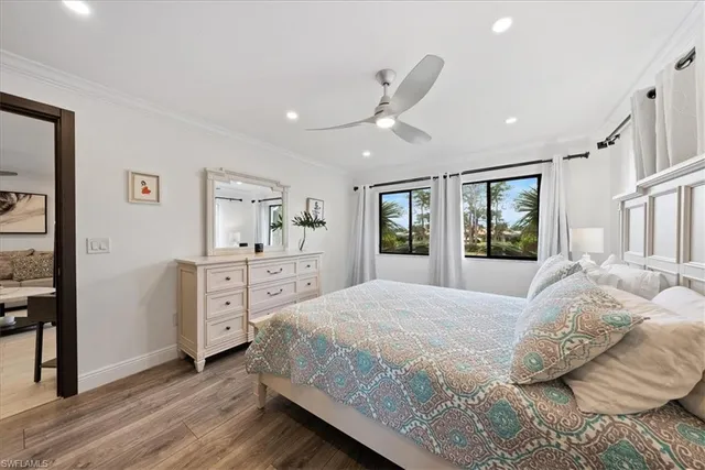 a spacious bedroom with a large bed and a dresser