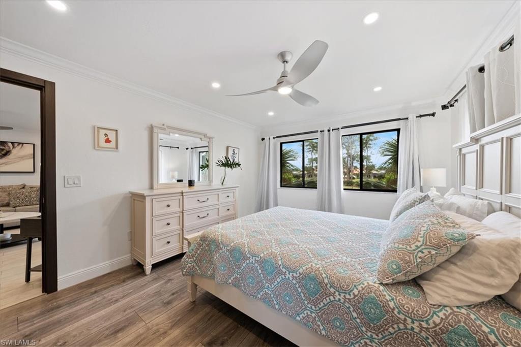 5841 Rattlesnake Hammock Road, Unit 2 Naples, FL 34113 - Photo 20 of 21 a spacious bedroom with a large bed and a dresser
