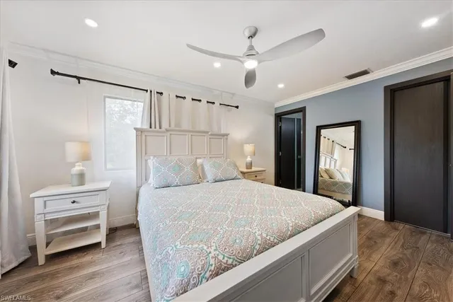 a bedroom with a large bed and a chandelier