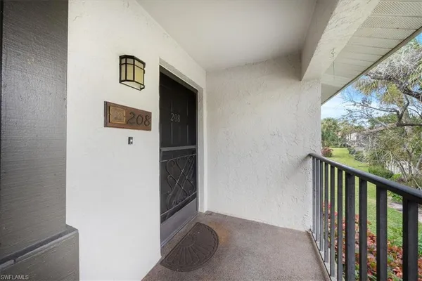 a view of a hallway with wooden floor and a wall painting