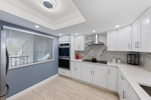 a kitchen with granite countertop a sink and cabinets