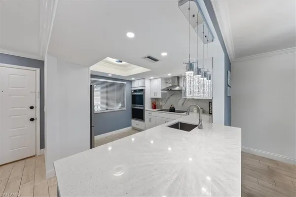 a large white room with kitchen view and living room