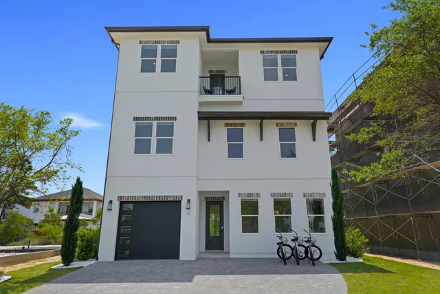 a view of a house with a yard and a porch