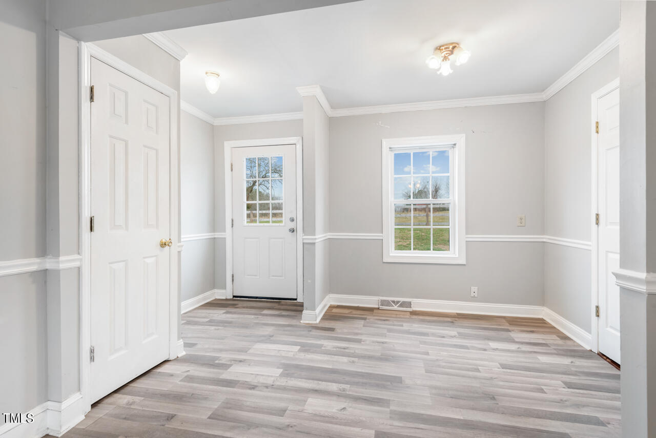 2034 Mt Harmony Church Road Rougemont, NC 27572 - Photo 13 of 40 a view of an empty room with wooden floor and a window