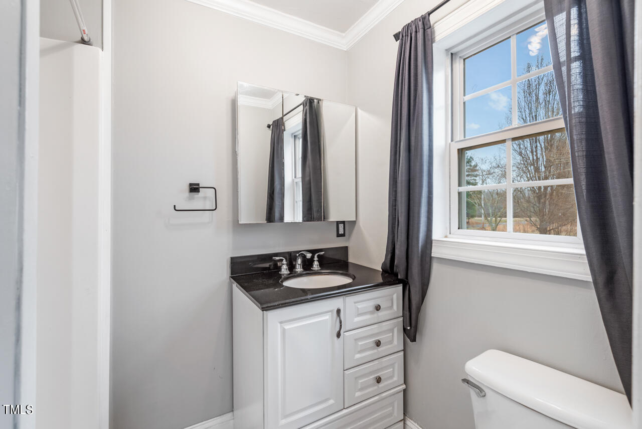2034 Mt Harmony Church Road Rougemont, NC 27572 - Photo 23 of 40 a bathroom with a toilet a sink and a window