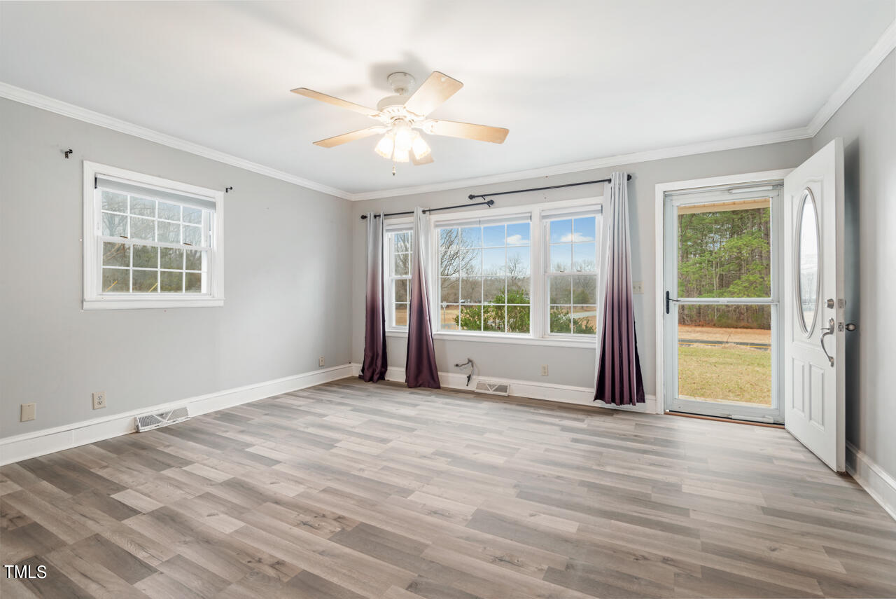 2034 Mt Harmony Church Road Rougemont, NC 27572 - Photo 5 of 40 a view of an empty room with a window and wooden floor