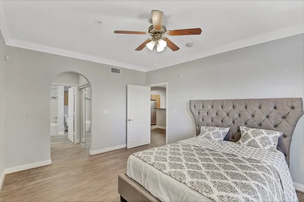 a bedroom with a bed and a chandelier