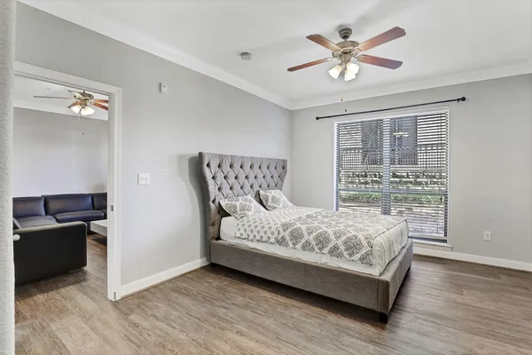 a bedroom with a bed and wooden floor