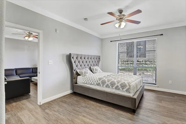 a bedroom with a bed and wooden floor