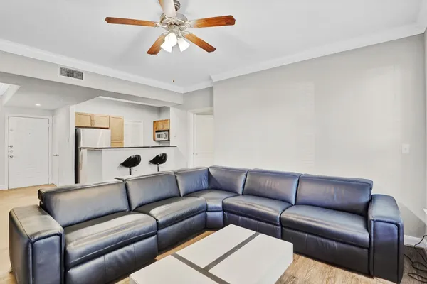 a living room with a couch and a ceiling fan