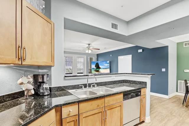 a kitchen with stainless steel appliances granite countertop a sink stove and cabinets