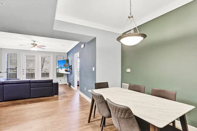 a view of a dining room with furniture window and wooden floor