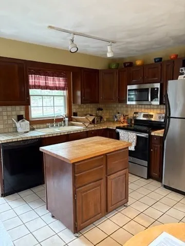 a kitchen with a sink and a stove top oven