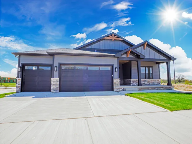 a front view of a house with yard and a garage