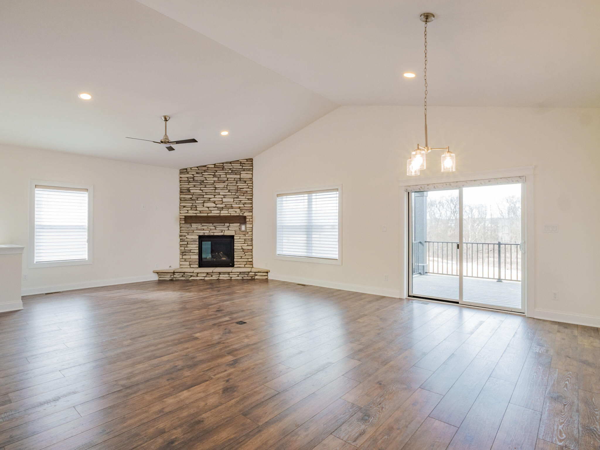 7522 East 116th Avenue Crown Point, IN 46307 - Photo 15 of 23 an empty room with wooden floor fireplace and windows