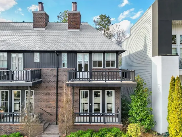 a view of brick house with large windows and a table