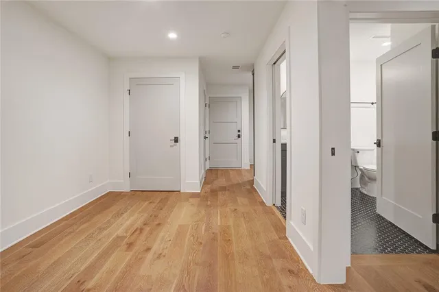 a view of a hallway with wooden floor
