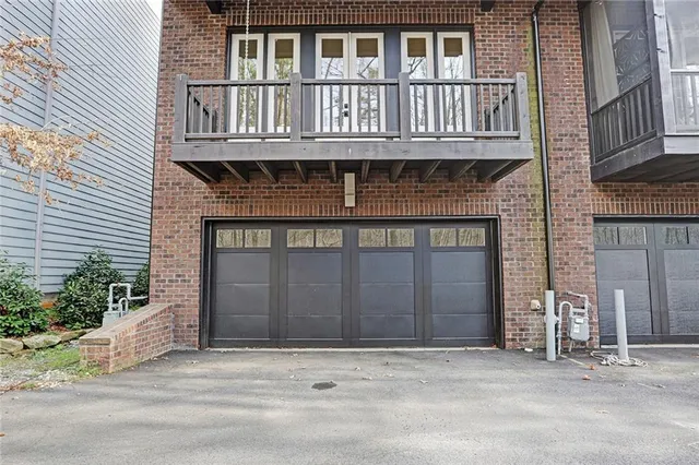 a front view of a house with a yard and a garage