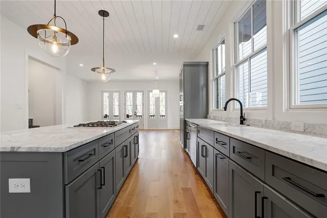 a kitchen with stainless steel appliances granite countertop a sink and stove