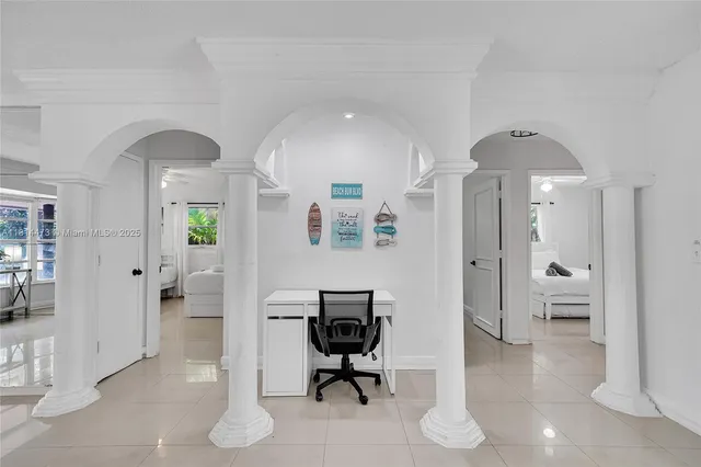 a kitchen that has a sink and a stove with wooden floor