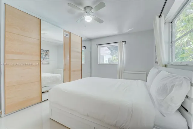 a kitchen with stainless steel appliances a stove a chimney a sink and a large window