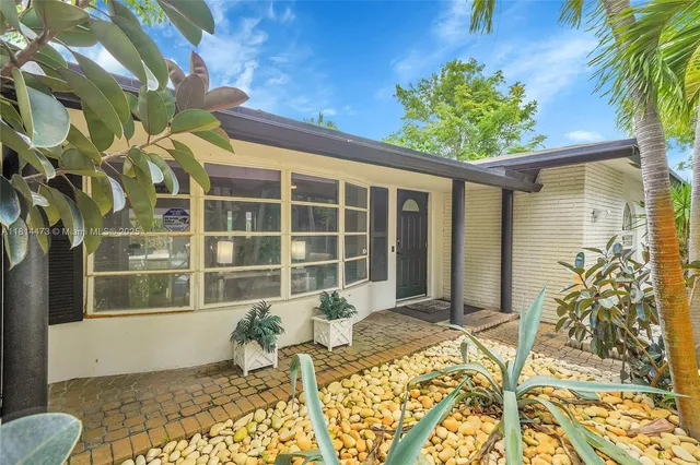 a living room with furniture kitchen view and a fireplace