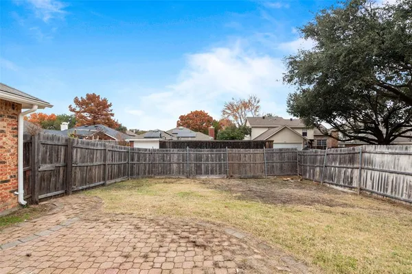 a view of a backyard with a large tree