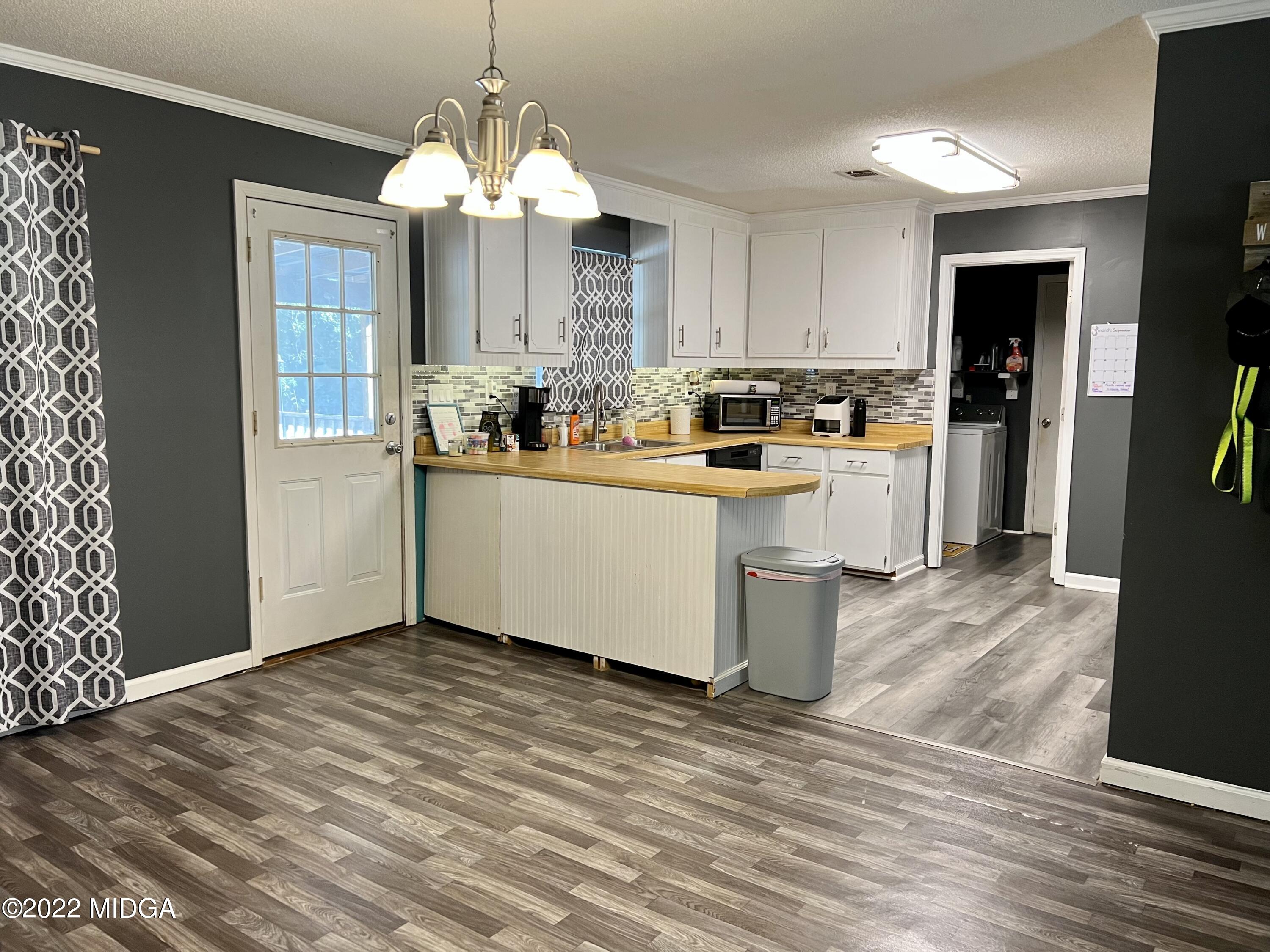 1817 Union Church Road Fort Valley, GA 31030 - Photo 15 of 18 a kitchen with stainless steel appliances a white stove top oven and a refrigerator