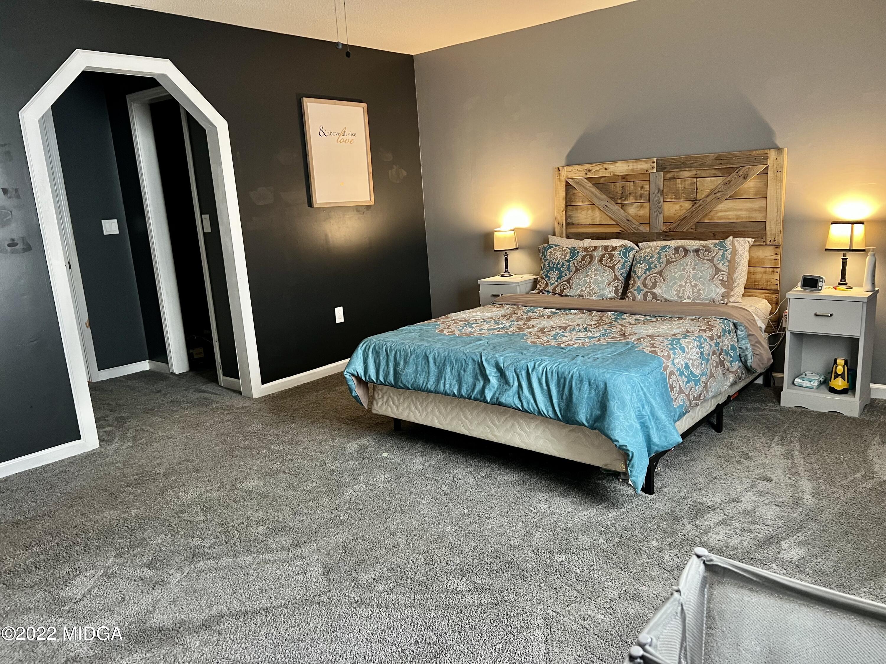 1817 Union Church Road Fort Valley, GA 31030 - Photo 5 of 18 a bedroom with a bed and a mirror
