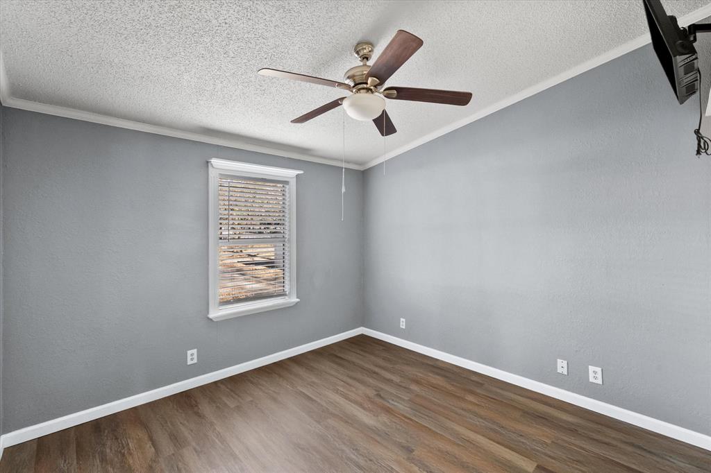 7634 Gibson Cemetery Road Mansfield, TX 76063 - Photo 6 of 11 wooden floor in an empty room with a window